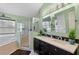 Bathroom featuring double sinks, granite countertops, a glass enclosed shower, and a soaking tub at 3188 Verbena Ct, Deltona, FL 32725
