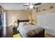 Bedroom featuring a ceiling fan, a closet with a full-length mirror, and built-in shelving at 3188 Verbena Ct, Deltona, FL 32725