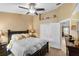 Bright bedroom features a ceiling fan, and a walk-in closet with a full-length mirror at 3188 Verbena Ct, Deltona, FL 32725