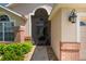 Charming front entrance with a screened doorway, brick accents, and well-maintained landscaping for curb appeal at 3188 Verbena Ct, Deltona, FL 32725