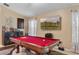 Inviting game room features a red pool table, a full bar setup, and a mounted television at 3188 Verbena Ct, Deltona, FL 32725