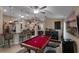 Entertaining game room with a vibrant red pool table, stylish bar, and neutral tones at 3188 Verbena Ct, Deltona, FL 32725