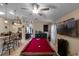 Spacious game room featuring a red felt billiard table, bar-height seating, and modern lighting fixtures at 3188 Verbena Ct, Deltona, FL 32725