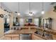 Open-concept kitchen with a large granite countertop, seamlessly connecting to the game room and living spaces at 3188 Verbena Ct, Deltona, FL 32725