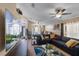 Spacious living area featuring a large sectional sofa, ceiling fan, and a television at 3188 Verbena Ct, Deltona, FL 32725