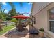 Outdoor patio featuring a dining area, a grill, and an umbrella for shade at 3188 Verbena Ct, Deltona, FL 32725