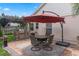 Outdoor patio with dining area, grill, and umbrella for a relaxing entertainment space at 3188 Verbena Ct, Deltona, FL 32725