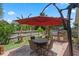 Outdoor patio featuring a dining set, grill, and a charming fountain for relaxing and entertaining at 3188 Verbena Ct, Deltona, FL 32725