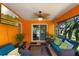 Bright sunroom offers a relaxing space with comfortable furniture and a view of the well-maintained yard at 3188 Verbena Ct, Deltona, FL 32725
