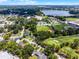 This aerial showcases homes near a local high school, sports fields, and the golf course at 3474 Fairway Ln, Orlando, FL 32804
