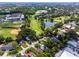 Aerial view showcasing a golf course, pond, and stadium nestled within a residential neighborhood at 3474 Fairway Ln, Orlando, FL 32804