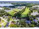 This aerial showcases homes near a local high school, sports fields, and the golf course at 3474 Fairway Ln, Orlando, FL 32804