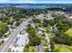 This aerial showcases houses on a tree-lined street and commercial buildings at 3474 Fairway Ln, Orlando, FL 32804