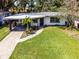 Aerial view of a home with a carport and green lawn at 3474 Fairway Ln, Orlando, FL 32804