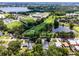 This aerial showcases homes near a local high school, sports fields, and the golf course at 3474 Fairway Ln, Orlando, FL 32804