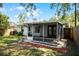 Outdoor patio featuring a screened-in enclosure and backyard access framed by mature landscaping at 3474 Fairway Ln, Orlando, FL 32804