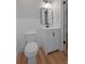 Well-lit half bathroom featuring a modern vanity and a sleek mirror at 3474 Fairway Ln, Orlando, FL 32804