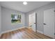 Modern bedroom with new flooring and trim, with a window and an ensuite bathroom at 3474 Fairway Ln, Orlando, FL 32804