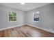 Bright bedroom with hardwood floors, two windows and neutral paint at 3474 Fairway Ln, Orlando, FL 32804