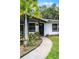 Front exterior featuring a welcoming front door and lush landscaping at 3474 Fairway Ln, Orlando, FL 32804