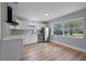 Bright and airy kitchen with sleek stainless steel appliances and a large window at 3474 Fairway Ln, Orlando, FL 32804