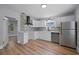 Modern kitchen featuring stainless steel appliances and stylish backsplash and flooring at 3474 Fairway Ln, Orlando, FL 32804