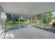 Spacious screened patio with access to the backyard, surrounded by lush greenery and trees at 3474 Fairway Ln, Orlando, FL 32804