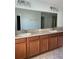 Bathroom vanity with granite countertops, double sinks, and a mirror at 3530 Rodrick Cir, Orlando, FL 32824