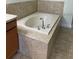 Bathroom with a tiled tub, creating a relaxing spa-like experience at 3530 Rodrick Cir, Orlando, FL 32824