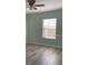 Bright bedroom with wood-look floors, ceiling fan and natural light at 3530 Rodrick Cir, Orlando, FL 32824