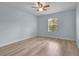 Neutral bedroom with hardwood floors, ceiling fan and window with natural light at 3530 Rodrick Cir, Orlando, FL 32824