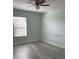Cozy bedroom featuring wood-look floors and a ceiling fan at 3530 Rodrick Cir, Orlando, FL 32824