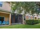View of the exterior of the building with a screened patio and lawn at 3530 Rodrick Cir, Orlando, FL 32824