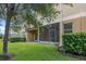 Exterior view of building with lawn, trees and a screened lanai at 3530 Rodrick Cir, Orlando, FL 32824