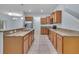 The kitchen is updated with granite counters, wood cabinets, stainless appliances and a tiled floor at 3530 Rodrick Cir, Orlando, FL 32824