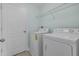 Convenient laundry room features a washer, dryer, shelving, and door for easy access at 3530 Rodrick Cir, Orlando, FL 32824