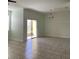 Open living room with tiled floors and sliding glass door to the patio at 3530 Rodrick Cir, Orlando, FL 32824