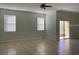Spacious living room with tiled floors, ceiling fan, and natural light at 3530 Rodrick Cir, Orlando, FL 32824
