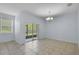 Bright living room featuring tile floors and sliding glass doors to an outdoor space at 3530 Rodrick Cir, Orlando, FL 32824