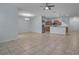 Open living space with tile flooring adjacent to a modern kitchen at 3530 Rodrick Cir, Orlando, FL 32824