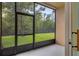 A screened porch offers a serene view of the lush greenery and wooded landscape at 3530 Rodrick Cir, Orlando, FL 32824