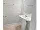 A clean, bright bathroom with a pedestal sink and neutral tiling at 3737 Plainview Dr, Orlando, FL 32824