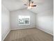 Bright bedroom with a vaulted ceiling, carpet flooring, a ceiling fan, and a large window at 3737 Plainview Dr, Orlando, FL 32824