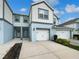 Charming townhome featuring a two-car garage, classic white doors, and a well-maintained driveway at 3737 Plainview Dr, Orlando, FL 32824