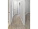 Well-lit hallway with access to multiple rooms, offering a seamless transition between spaces at 3737 Plainview Dr, Orlando, FL 32824