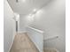 Upstairs hallway with neutral walls, carpet, and white trim creates a clean and inviting path at 3737 Plainview Dr, Orlando, FL 32824