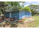 Angled view showcasing the back of the home with blue siding and an air conditioning unit installed on the side at 4515 Isaac Ln, Sanford, FL 32771