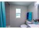 Charming bathroom featuring a gray vanity, toilet, and a window with a view at 4515 Isaac Ln, Sanford, FL 32771