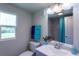 Well-lit bathroom featuring a gray vanity, toilet, and a window with a view at 4515 Isaac Ln, Sanford, FL 32771