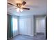 Bright bedroom with wood-look flooring, gray walls, ceiling fan and closet at 4515 Isaac Ln, Sanford, FL 32771